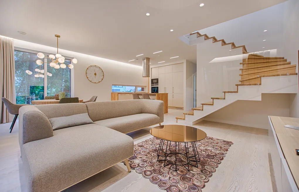 Open-concept living room with a beige sectional and gold coffee table